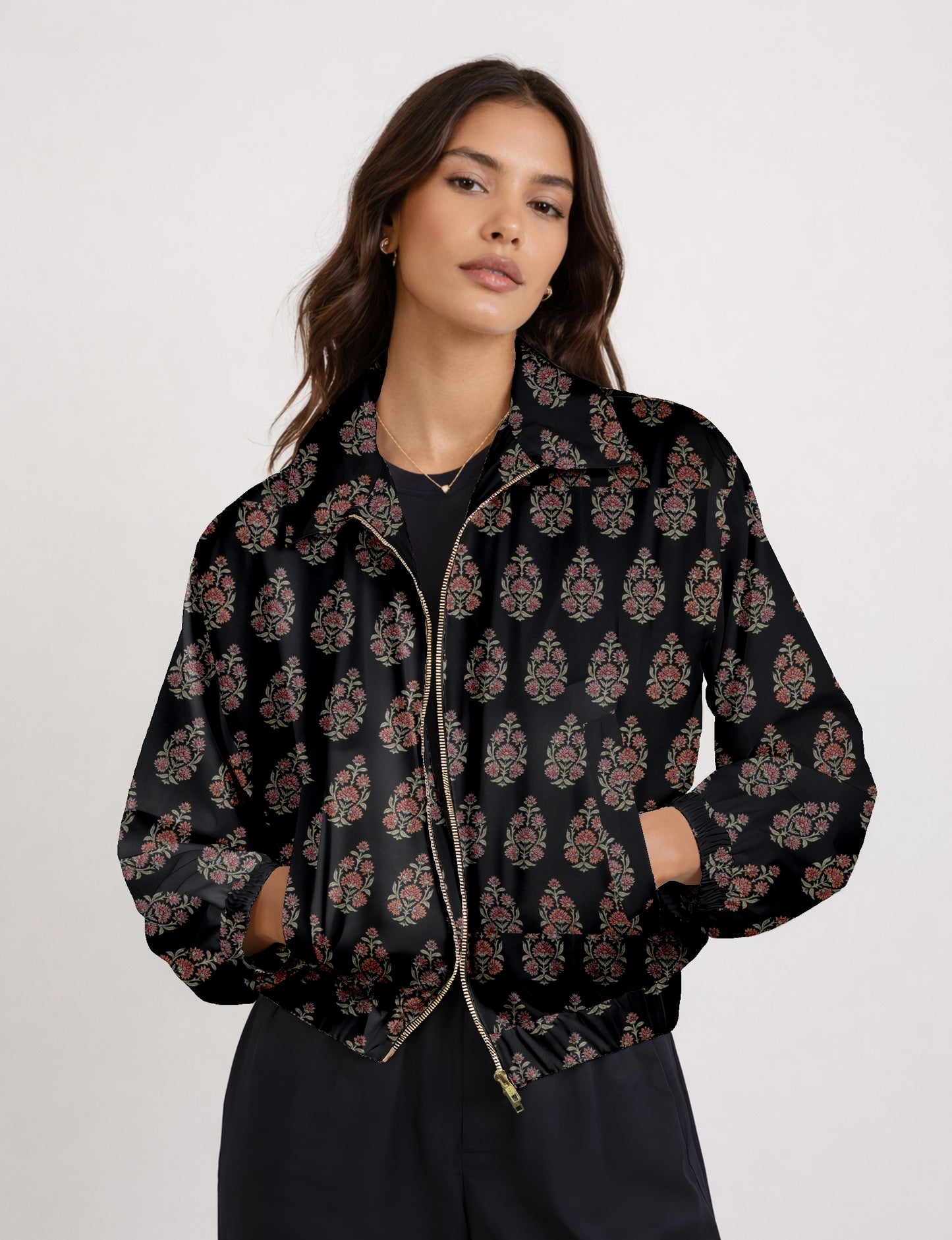 Women's cropped bomber jacket with twin metallic front zippers, welt pockets, elasticated hem and cuffs, and contrast sari print lining.