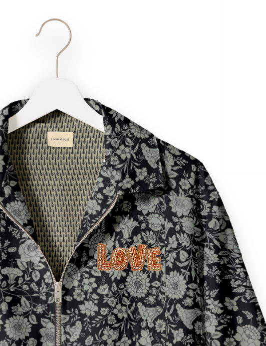 Love Bomber Jacket made from recycled fabric, featuring hand-stitched Aari embroidery. A unique piece of zero-waste clothing, part of the circular fashion movement. Designed with upcycled materials for a stylish yet environmentally friendly clothing choice.