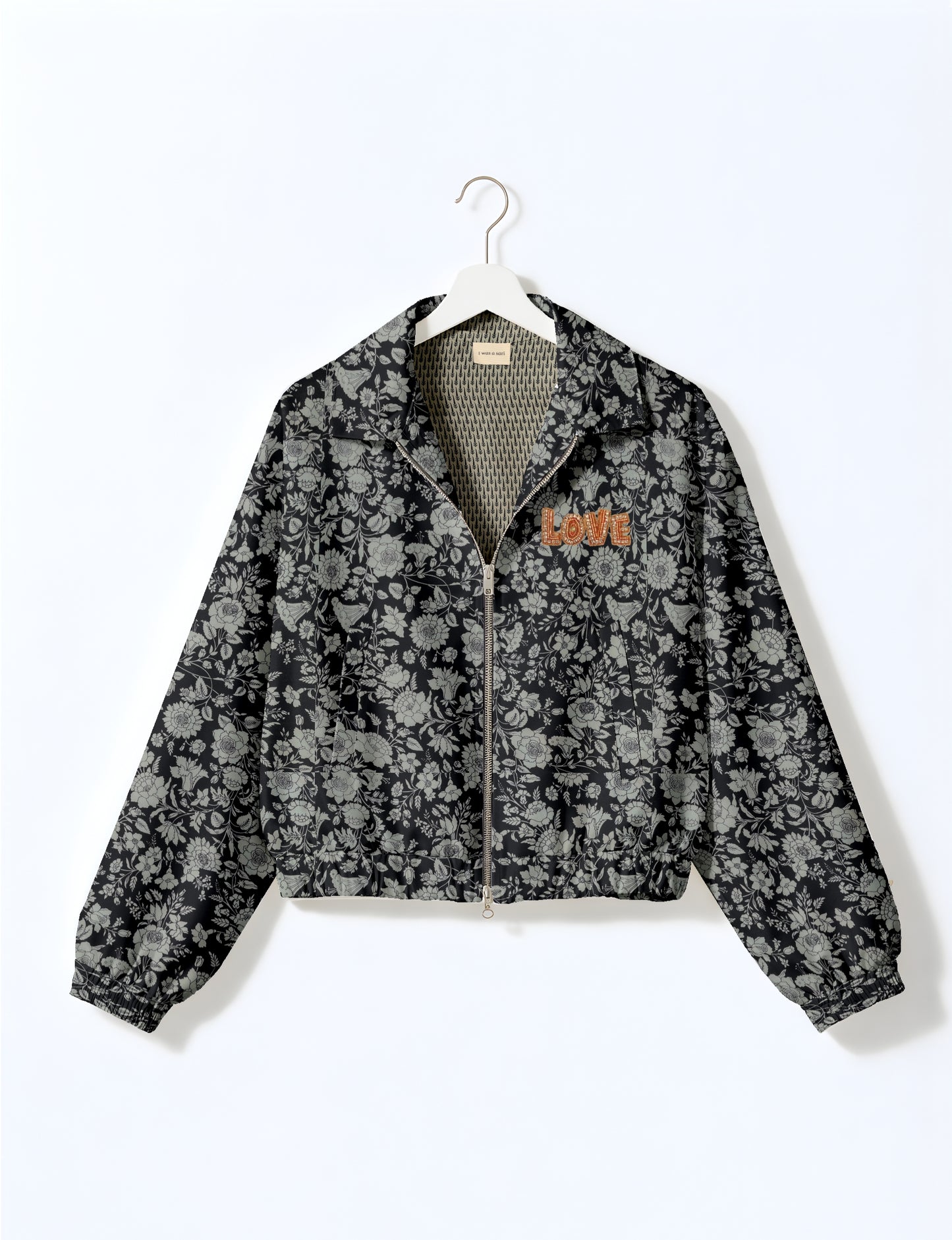 Love Bomber Jacket made from recycled fabric, featuring hand-stitched Aari embroidery. A unique piece of zero-waste clothing, part of the circular fashion movement. Designed with upcycled materials for a stylish yet environmentally friendly clothing choice.