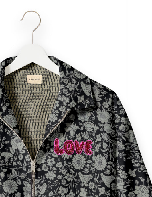 Love Bomber Jacket made from recycled fabric, featuring hand-stitched Aari embroidery. A unique piece of zero-waste clothing, part of the circular fashion movement. Designed with upcycled materials for a stylish yet environmentally friendly clothing choice.