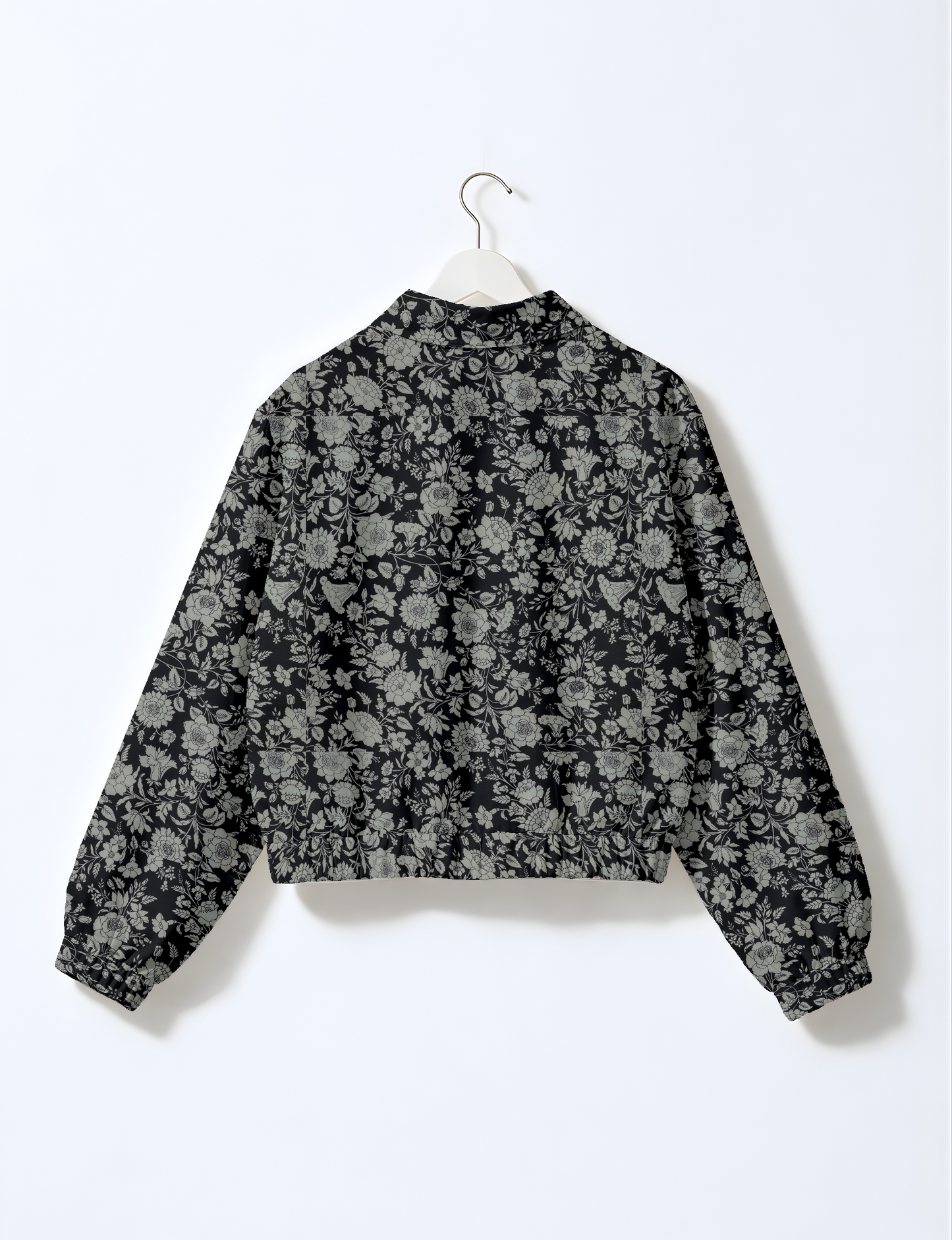 Women's cropped bomber jacket with twin metallic front zippers, welt pockets, elasticated hem and cuffs, and contrast sari print lining.
