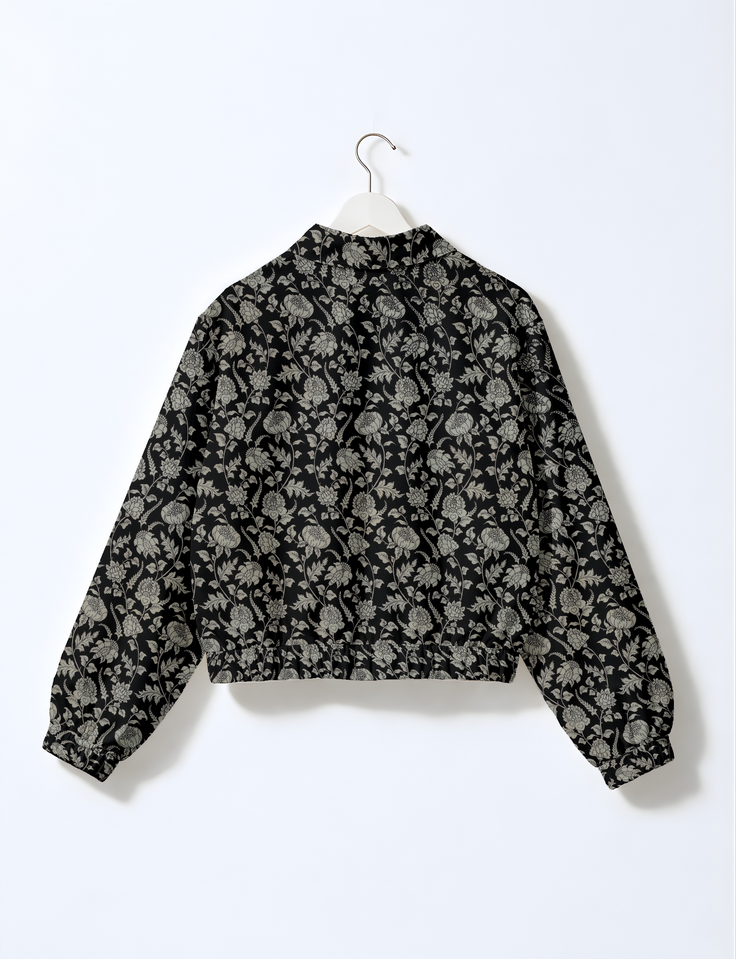 Women's cropped bomber jacket with twin metallic front zippers, welt pockets, elasticated hem and cuffs, and contrast sari print lining.