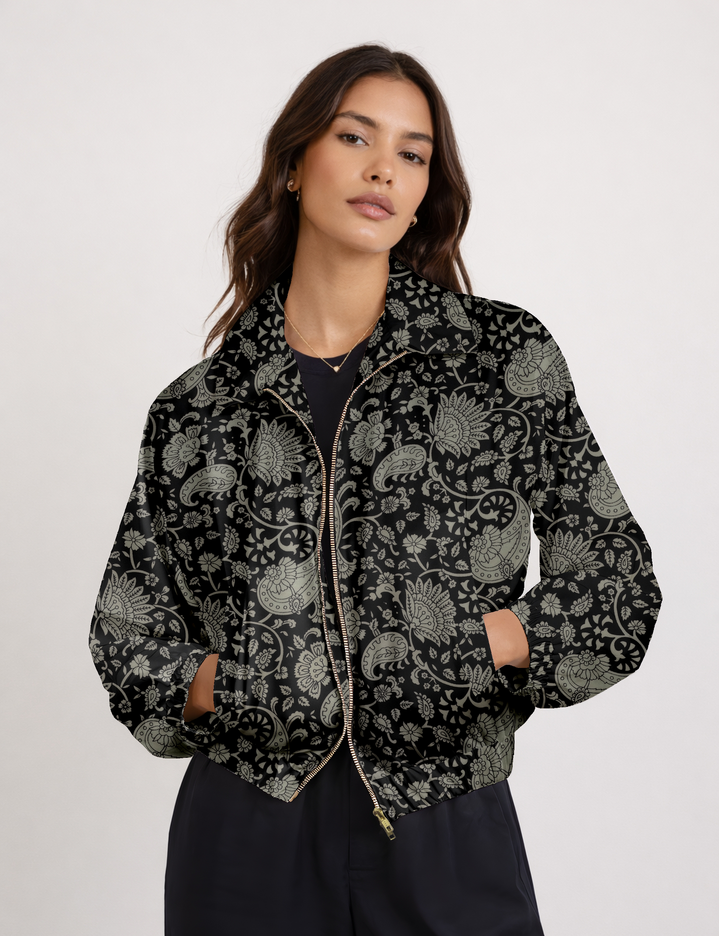 Women's cropped bomber jacket with twin metallic front zippers, welt pockets, elasticated hem and cuffs, and contrast sari print lining.
