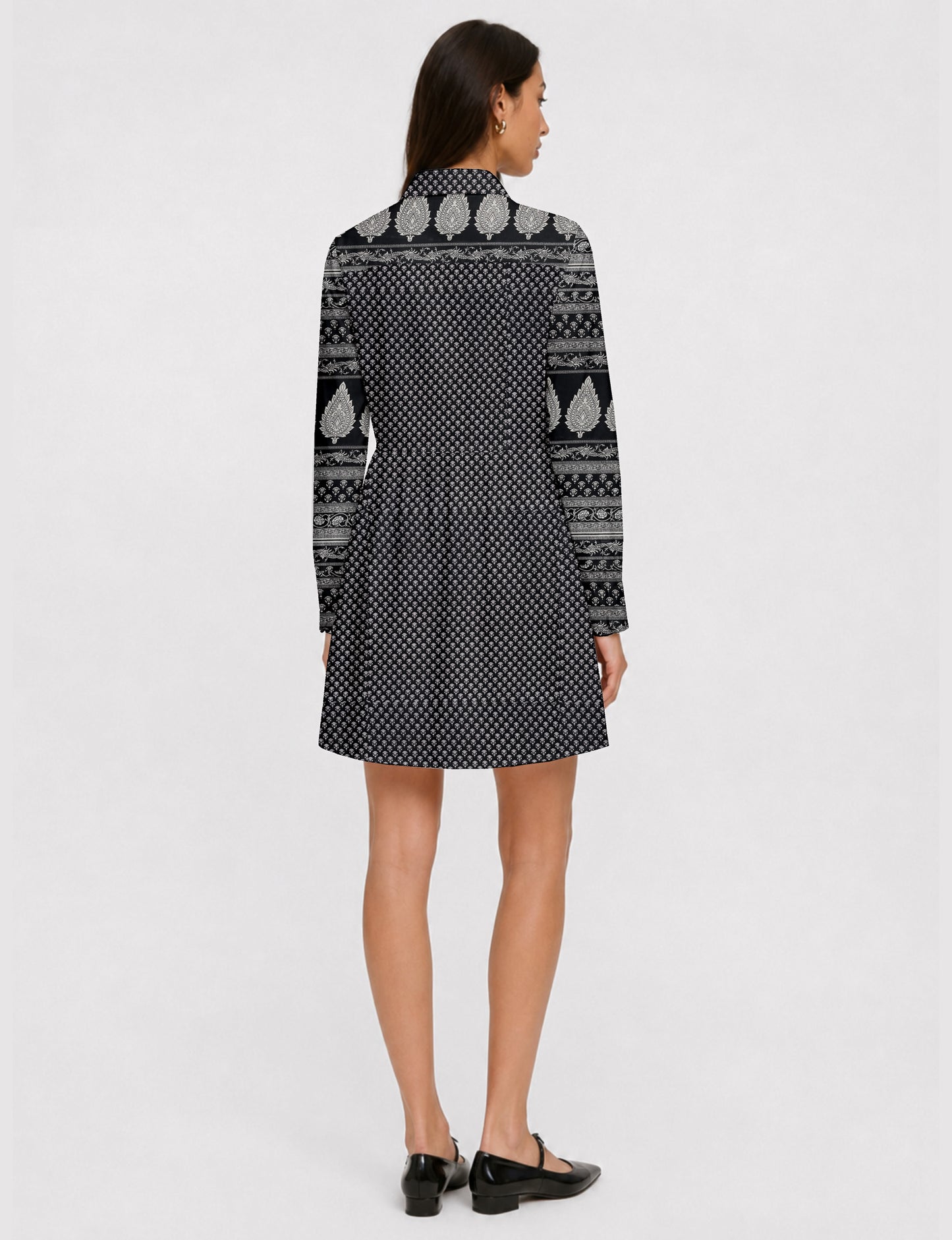 Short shirt dress with a relaxed A-line silhouette, point collar, partial button placket, gathered waist, side pockets, and full-length cuffed sleeves.