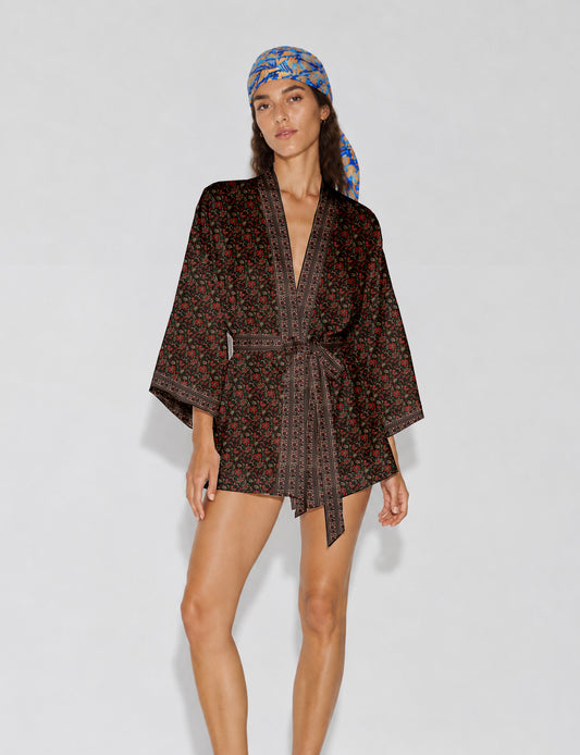 Short kimono robe with wrap front, V-neckline, wide sleeves, waist tie, and concealed skort detail.