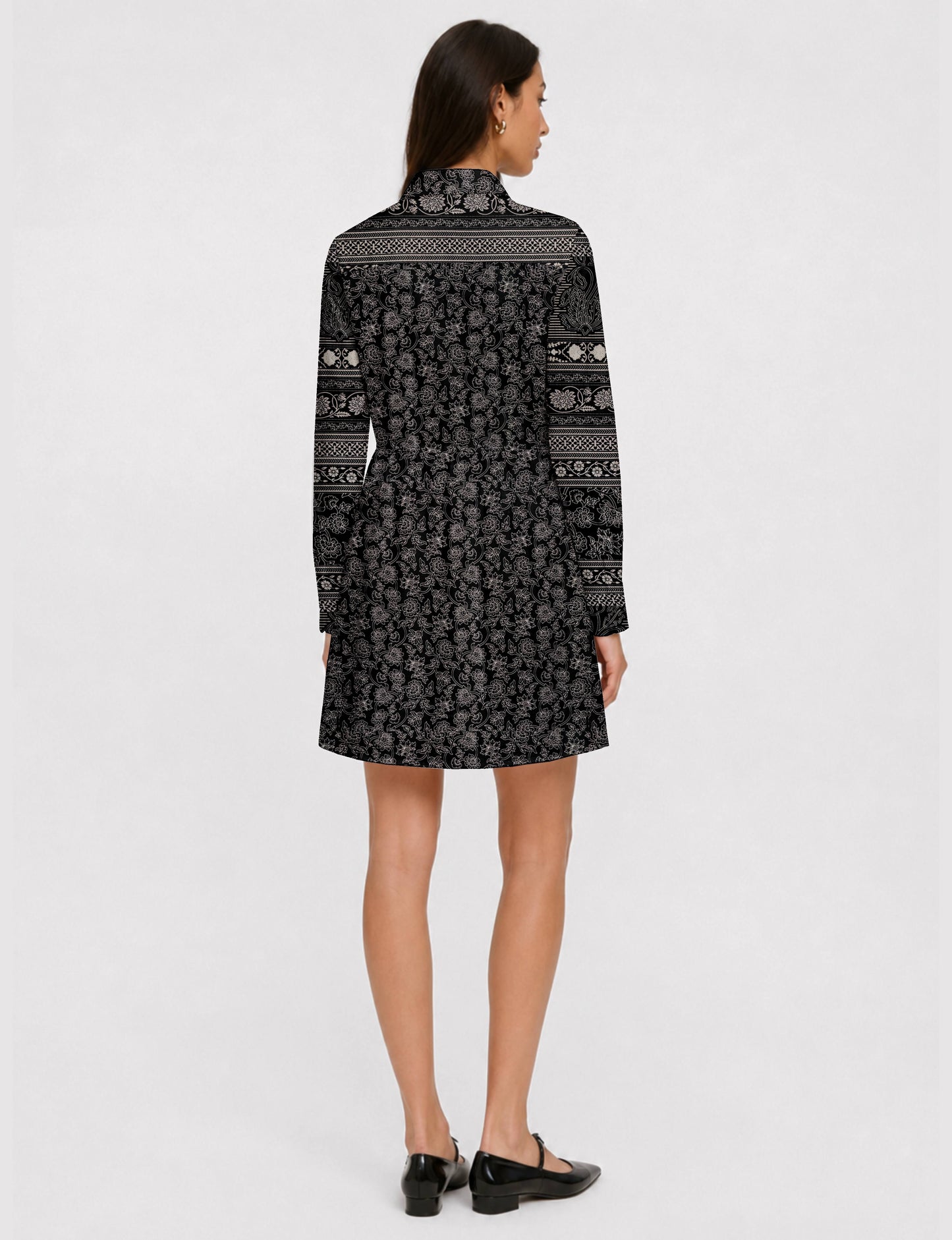 Short shirt dress with a relaxed A-line silhouette, point collar, partial button placket, gathered waist, side pockets, and full-length cuffed sleeves.