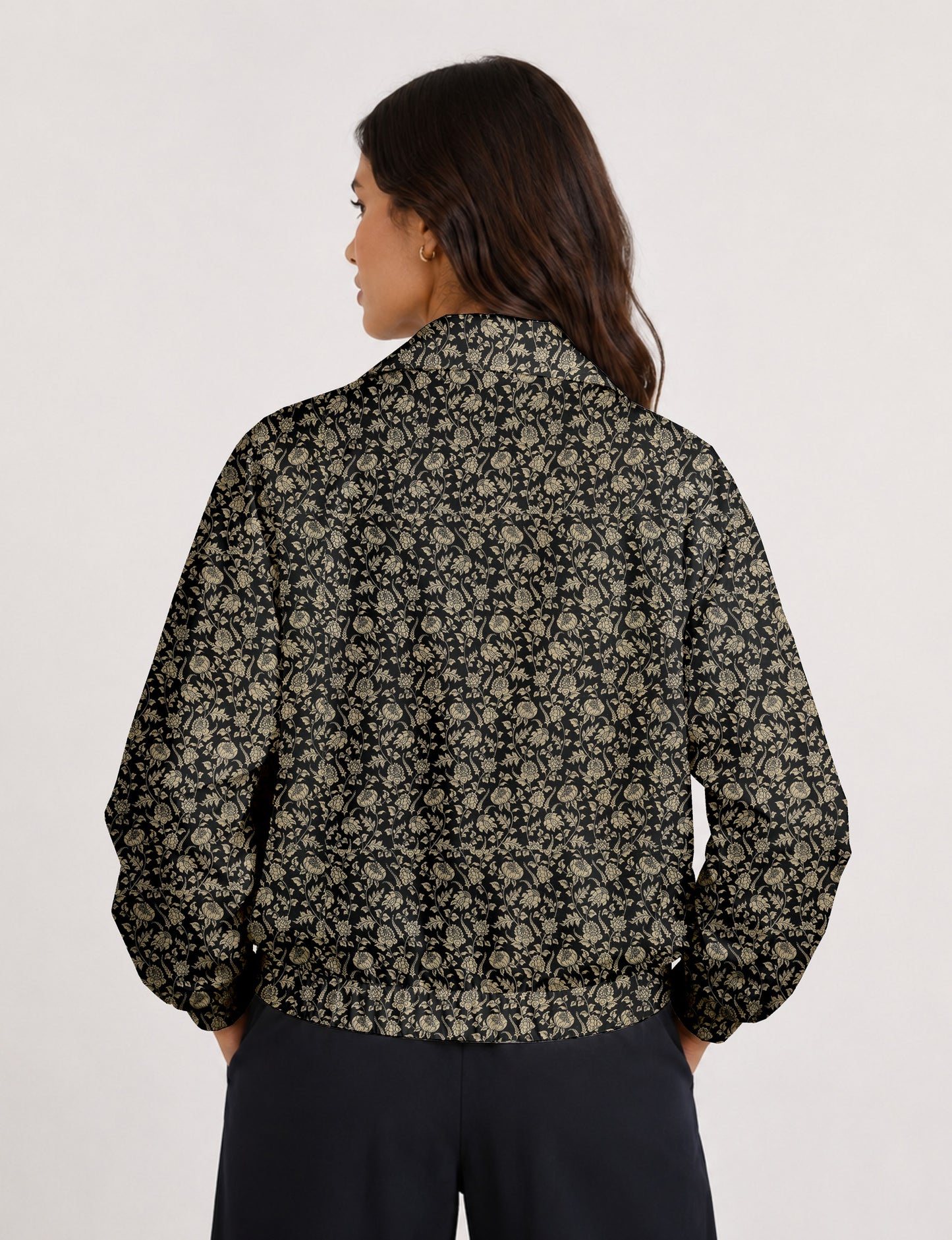Woman wearing a yellow floral bomber jacket with front zipper, elastic cuffs, and side pockets, shown from front view