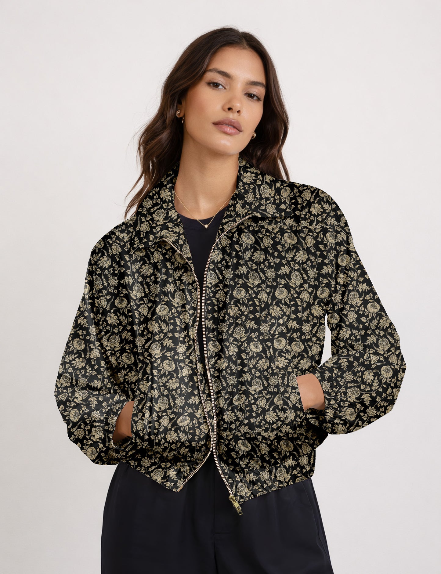 Woman wearing a yellow floral bomber jacket with front zipper, elastic cuffs, and side pockets, shown from front view