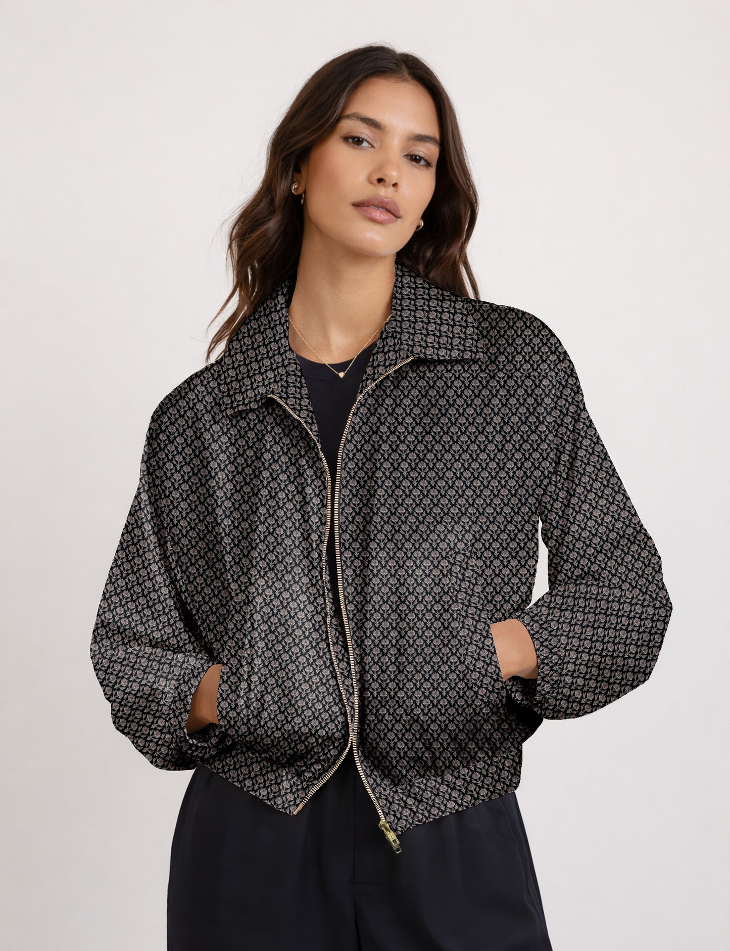 Woman wearing a yellow floral bomber jacket with front zipper, elastic cuffs, and side pockets, shown from front view