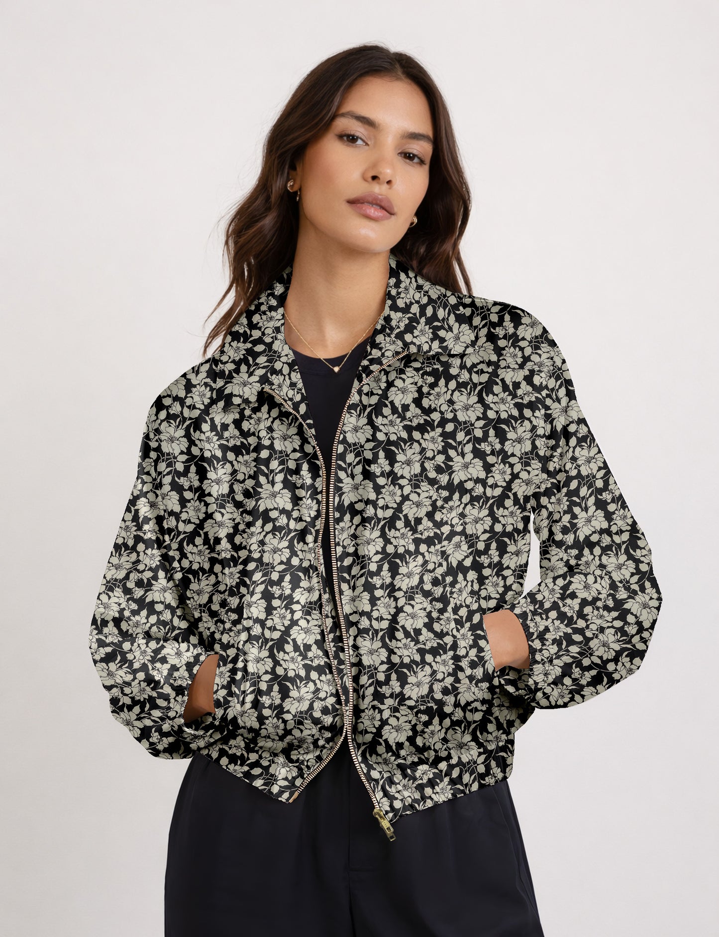 Woman wearing a yellow floral bomber jacket with front zipper, elastic cuffs, and side pockets, shown from front view