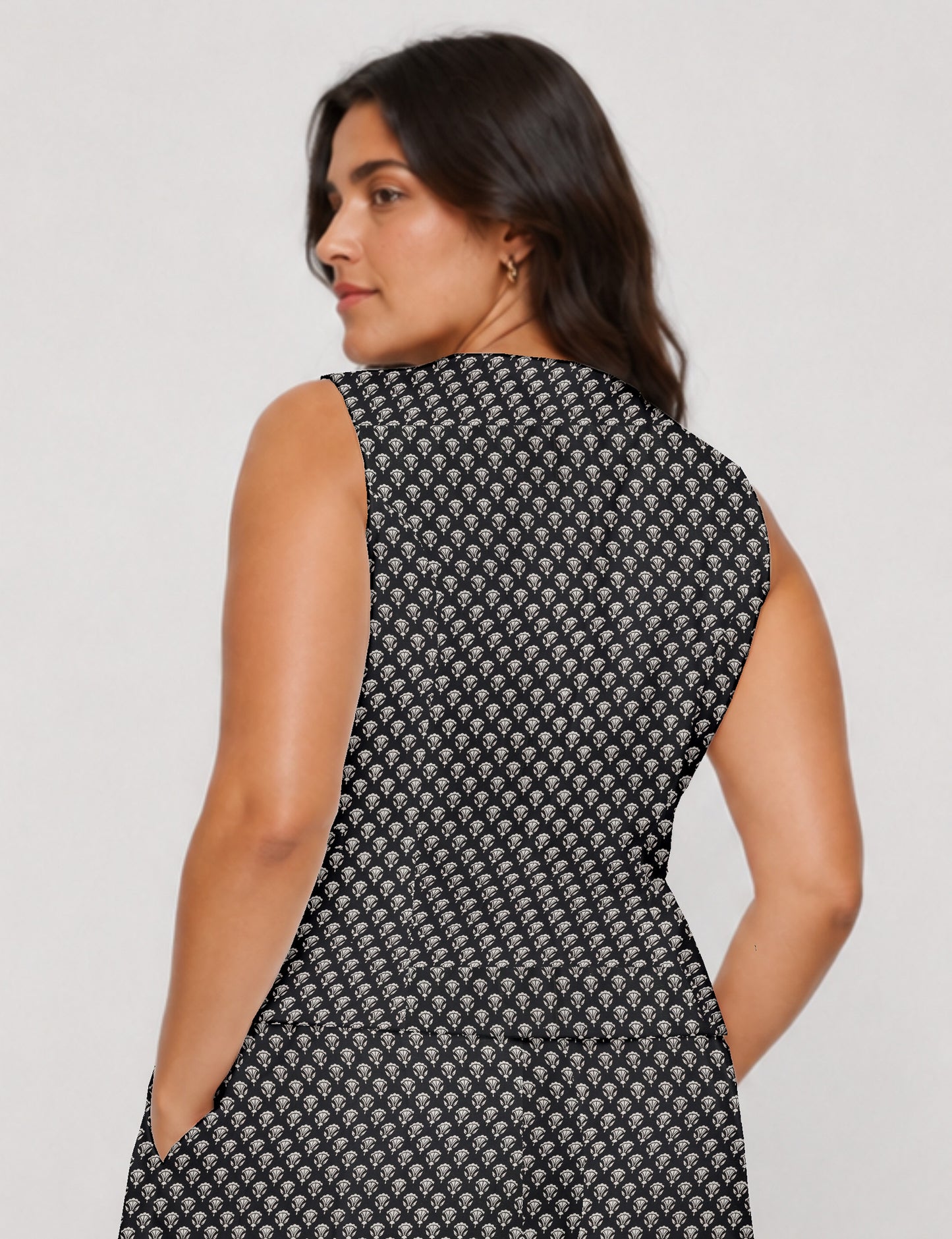 Women's fitted waistcoat with V-neck, single-breasted button closure, tailored silhouette, and pointed hem in sustainable fashion.