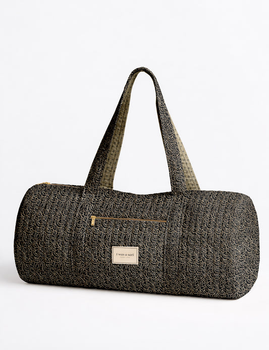 Brown paisley quilted bowling bag with dual handles, front zipper pocket, and "I was a sari" label on front side