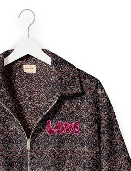 Love Bomber Jacket made from recycled fabric, featuring hand-stitched Aari embroidery. A unique piece of zero-waste clothing, part of the circular fashion movement. Designed with upcycled materials for a stylish yet environmentally friendly clothing choice.