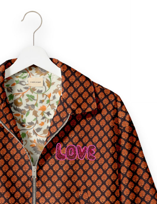 Love Bomber Jacket made from recycled fabric, featuring hand-stitched Aari embroidery. A unique piece of zero-waste clothing, part of the circular fashion movement. Designed with upcycled materials for a stylish yet environmentally friendly clothing choice.