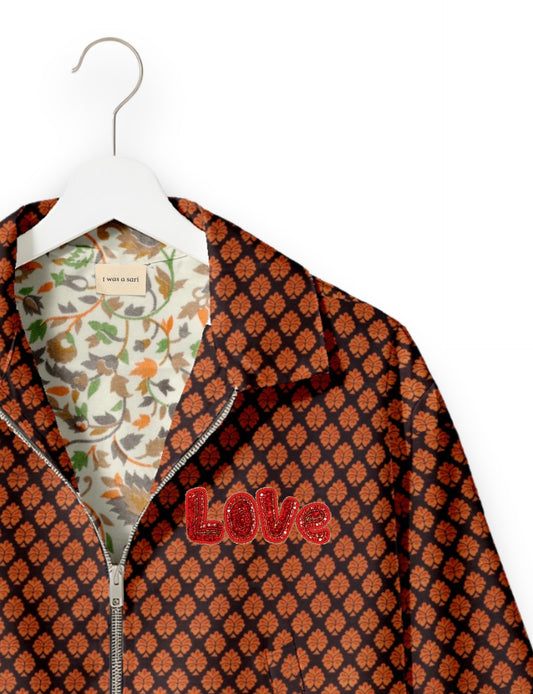 Love Bomber Jacket made from recycled fabric, featuring hand-stitched Aari embroidery. A unique piece of zero-waste clothing, part of the circular fashion movement. Designed with upcycled materials for a stylish yet environmentally friendly clothing choice.