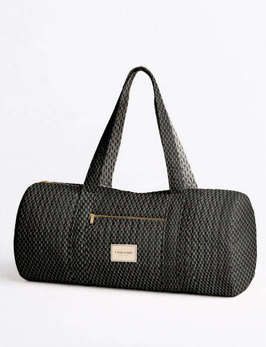 Beige quilted bowling bag with micro floral pattern, front zipper pocket, and dual handles with striped inner lining