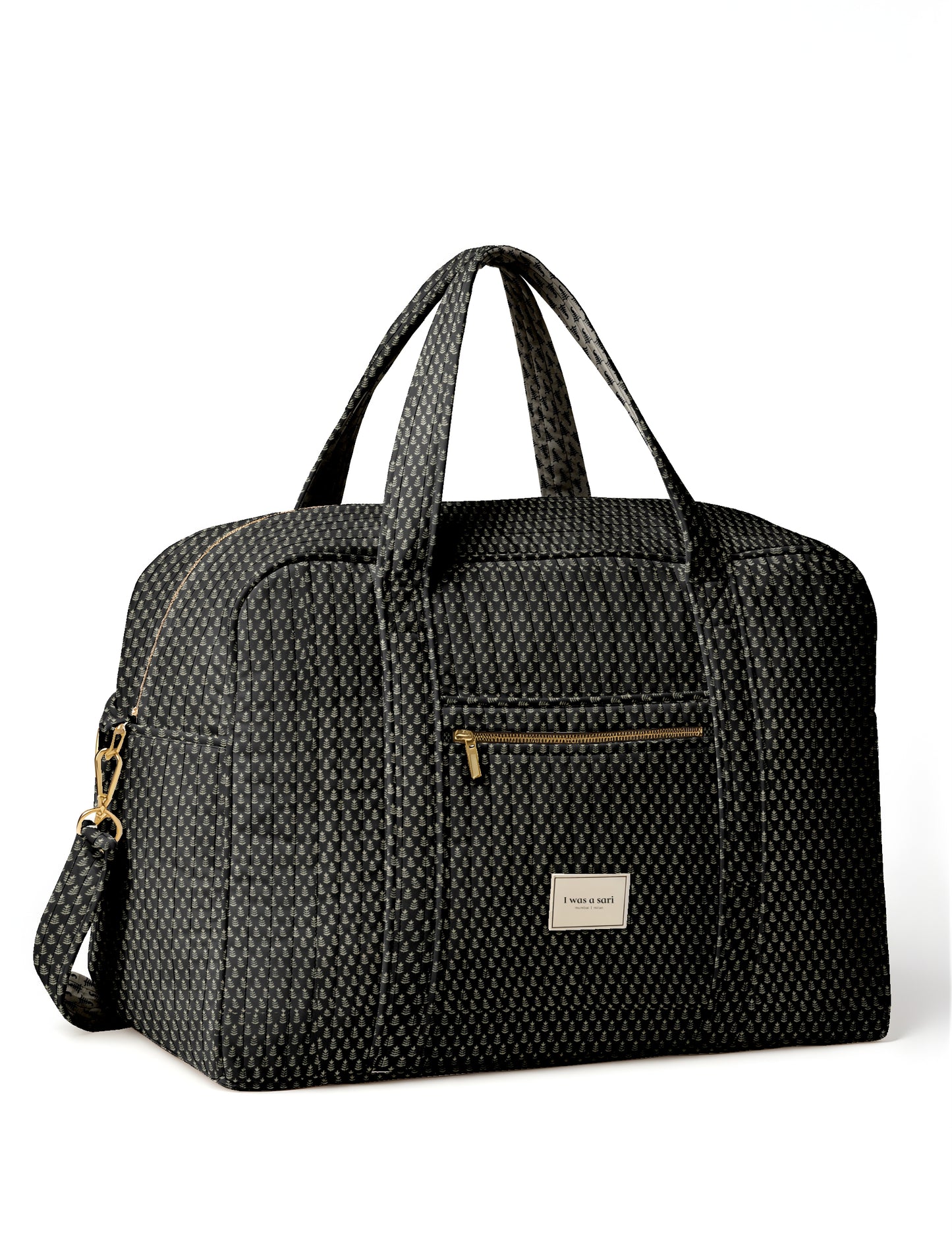Black quilted duffle bag with micro leaf pattern, dual handles, front zip pocket, and detachable shoulder strap, front label
