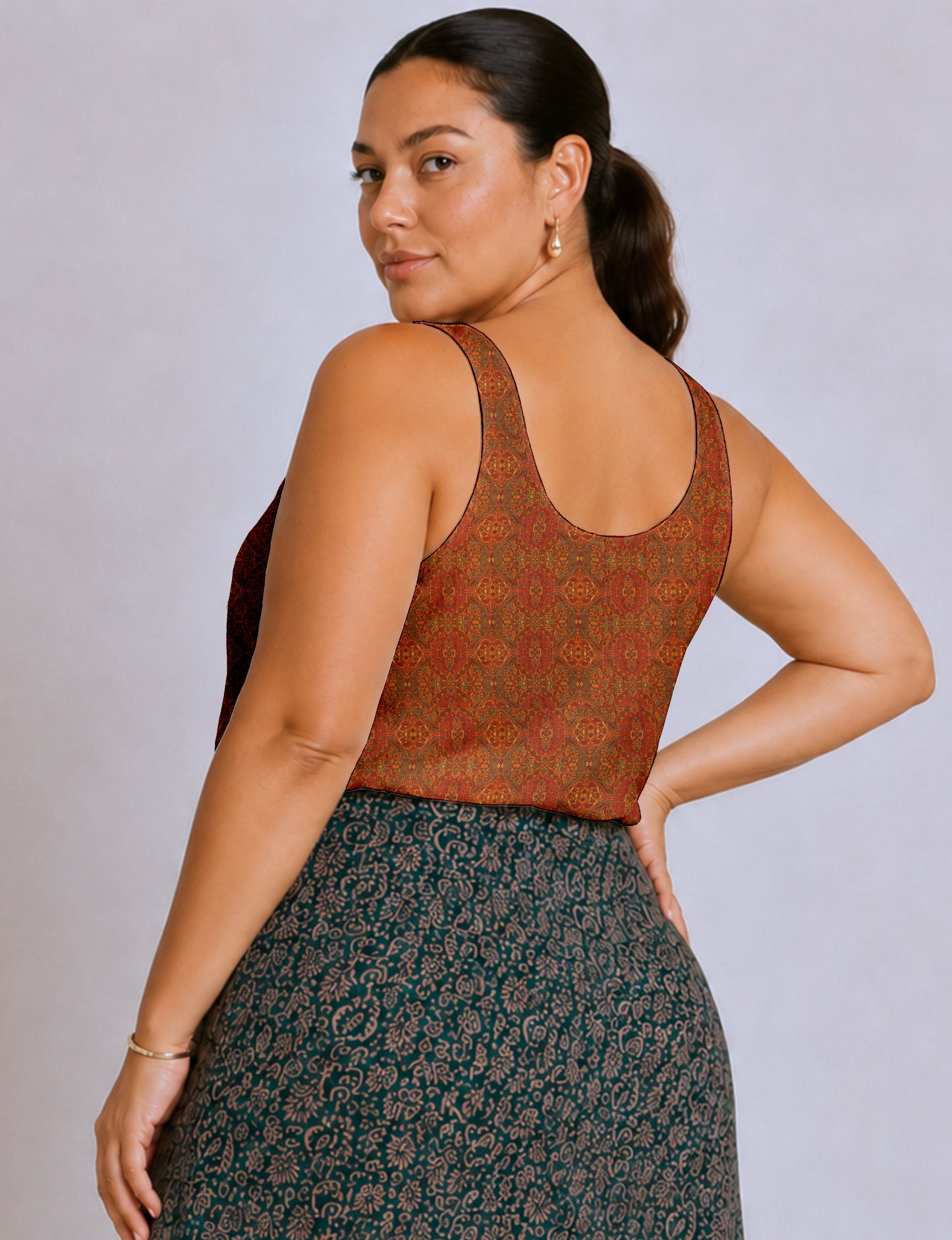 Women's sleeveless blouse with a relaxed straight fit, wide scoop neckline, deep scoop back, and hip-length silhouette.