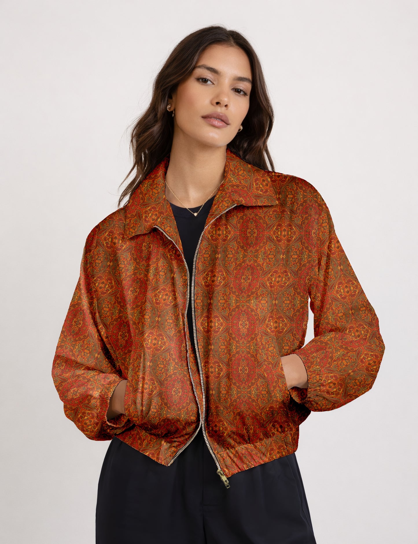 Woman wearing a yellow bomber jacket with a micro geometric pattern, front zipper, and side pockets, paired with black pants