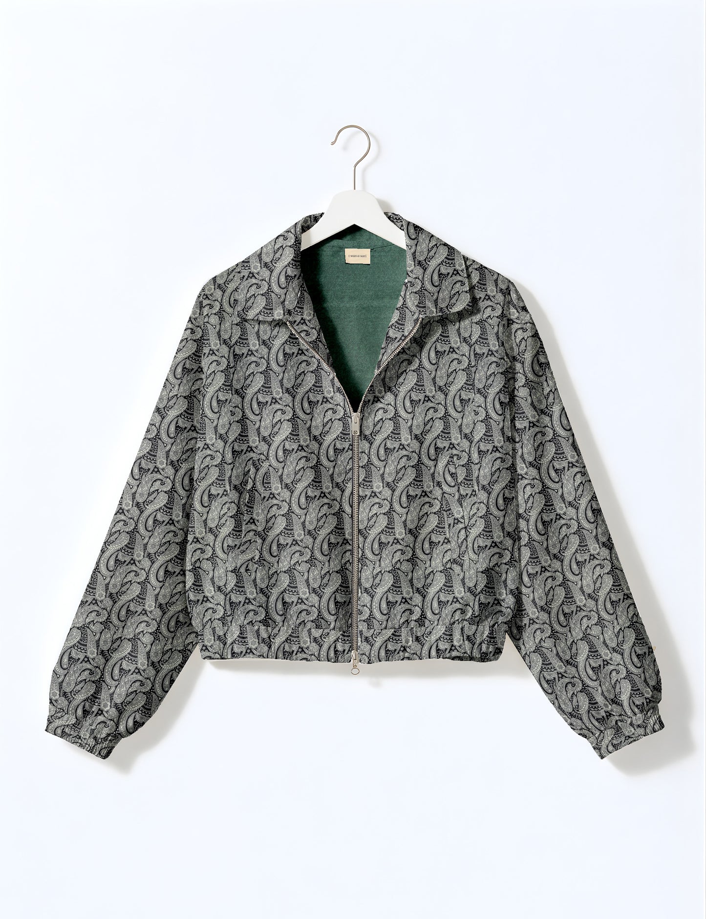 Women's cropped bomber jacket with twin metallic front zippers, welt pockets, elasticated hem and cuffs, and contrast sari print lining.