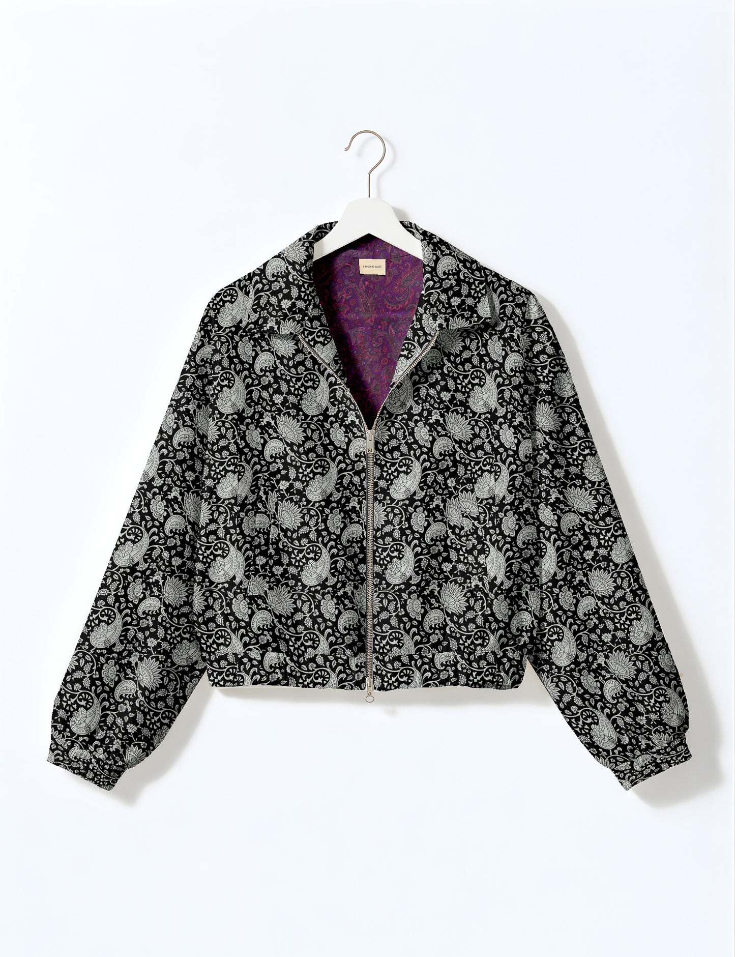 Woman wearing a yellow floral bomber jacket with front zipper, elastic cuffs, and side pockets, shown from front view