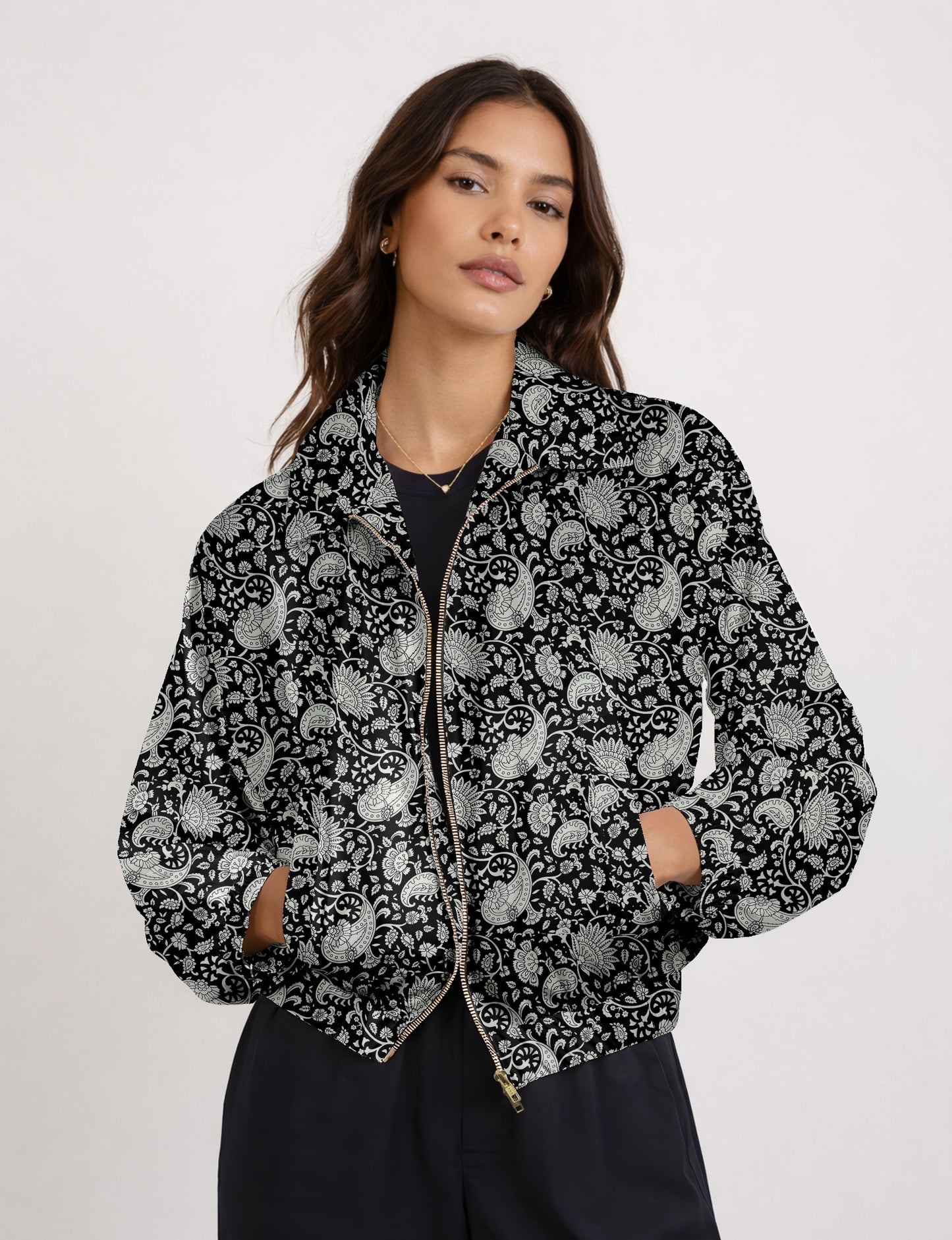 Brown floral bomber jacket with front zipper, elastic cuffs and hem, hanging on white hanger, red floral inner lining visible
