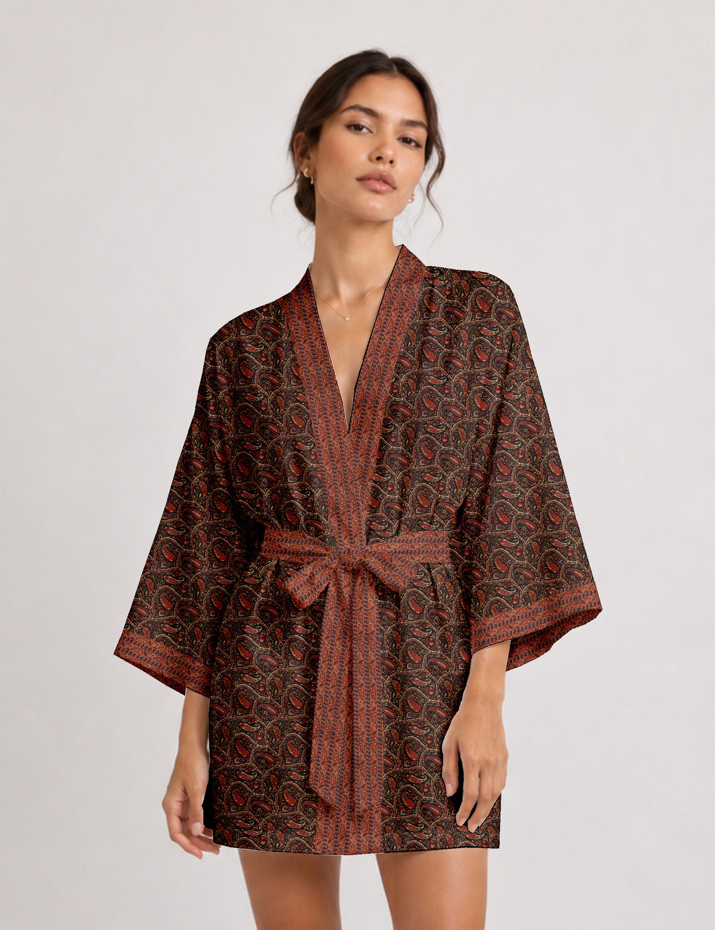 Short kimono robe with wrap front, V-neckline, wide sleeves, waist tie, and concealed skort detail.