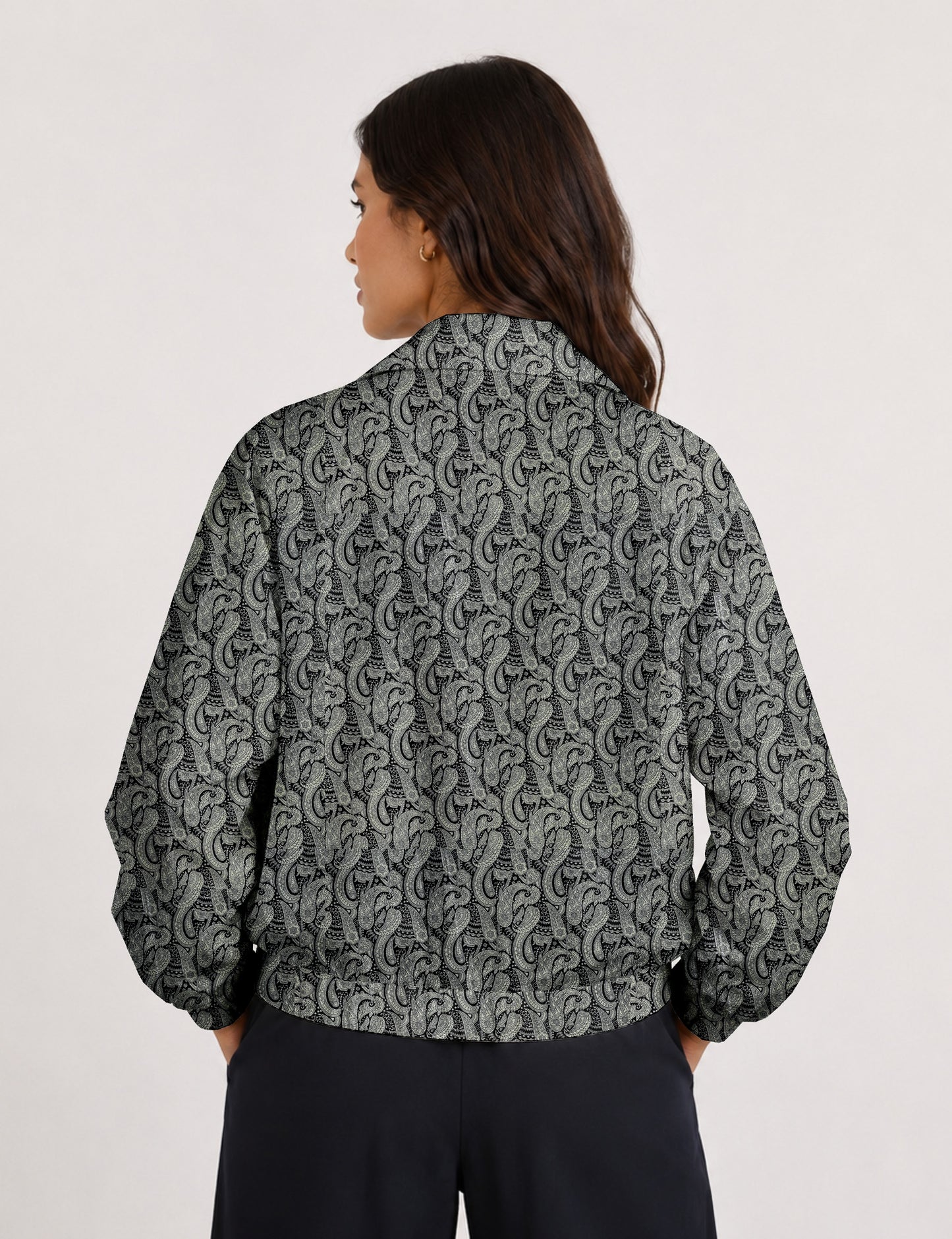 Brown floral bomber jacket with front zipper, elastic cuffs and hem, hanging on white hanger, red floral inner lining visible