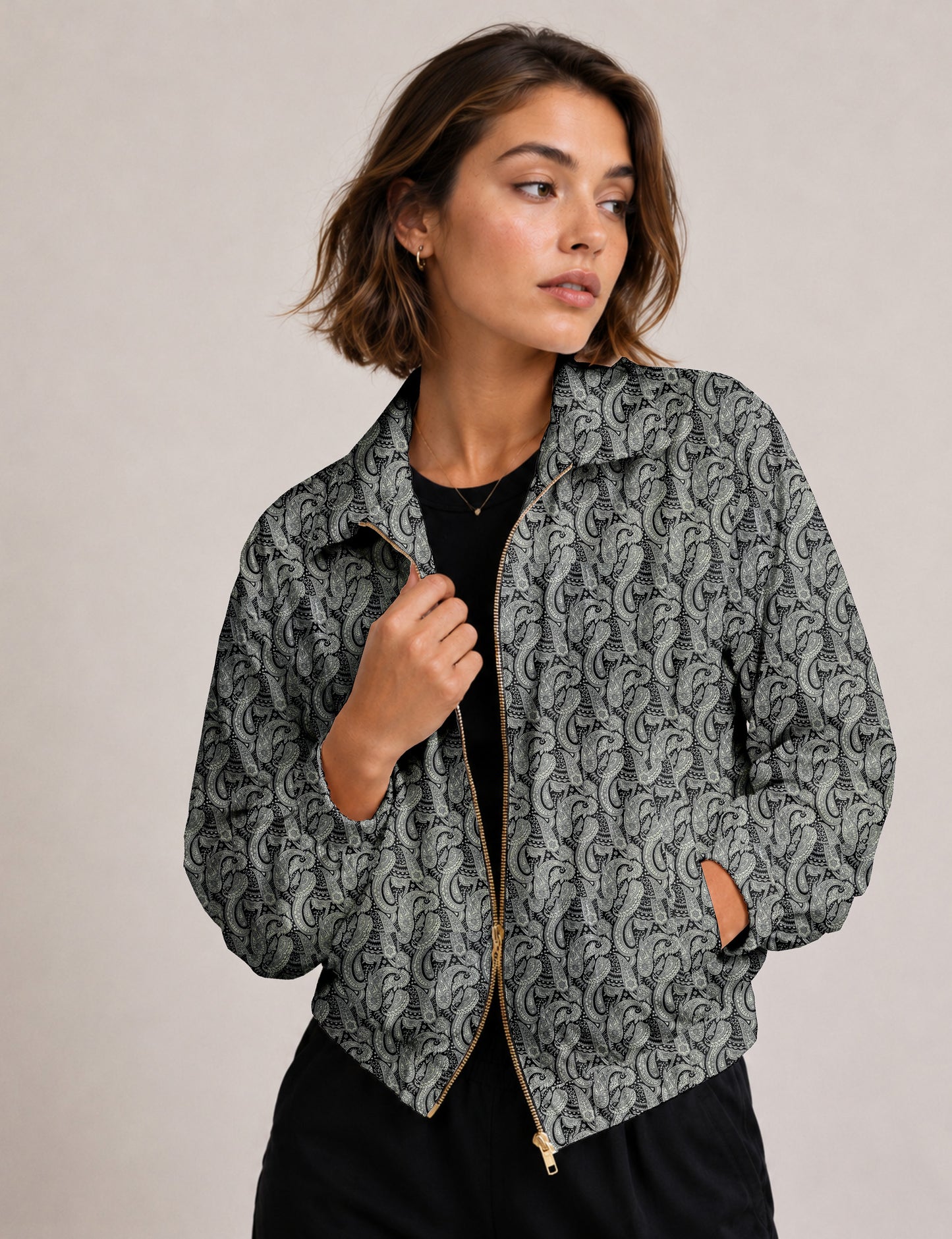 Woman wearing a yellow floral bomber jacket with front zipper, elastic cuffs, and side pockets, shown from front view