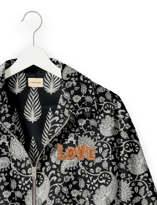 Love Bomber Jacket made from recycled fabric, featuring hand-stitched Aari embroidery. A unique piece of zero-waste clothing, part of the circular fashion movement. Designed with upcycled materials for a stylish yet environmentally friendly clothing choice.