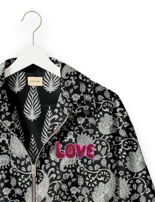 Love Bomber Jacket made from recycled fabric, featuring hand-stitched Aari embroidery. A unique piece of zero-waste clothing, part of the circular fashion movement. Designed with upcycled materials for a stylish yet environmentally friendly clothing choice.