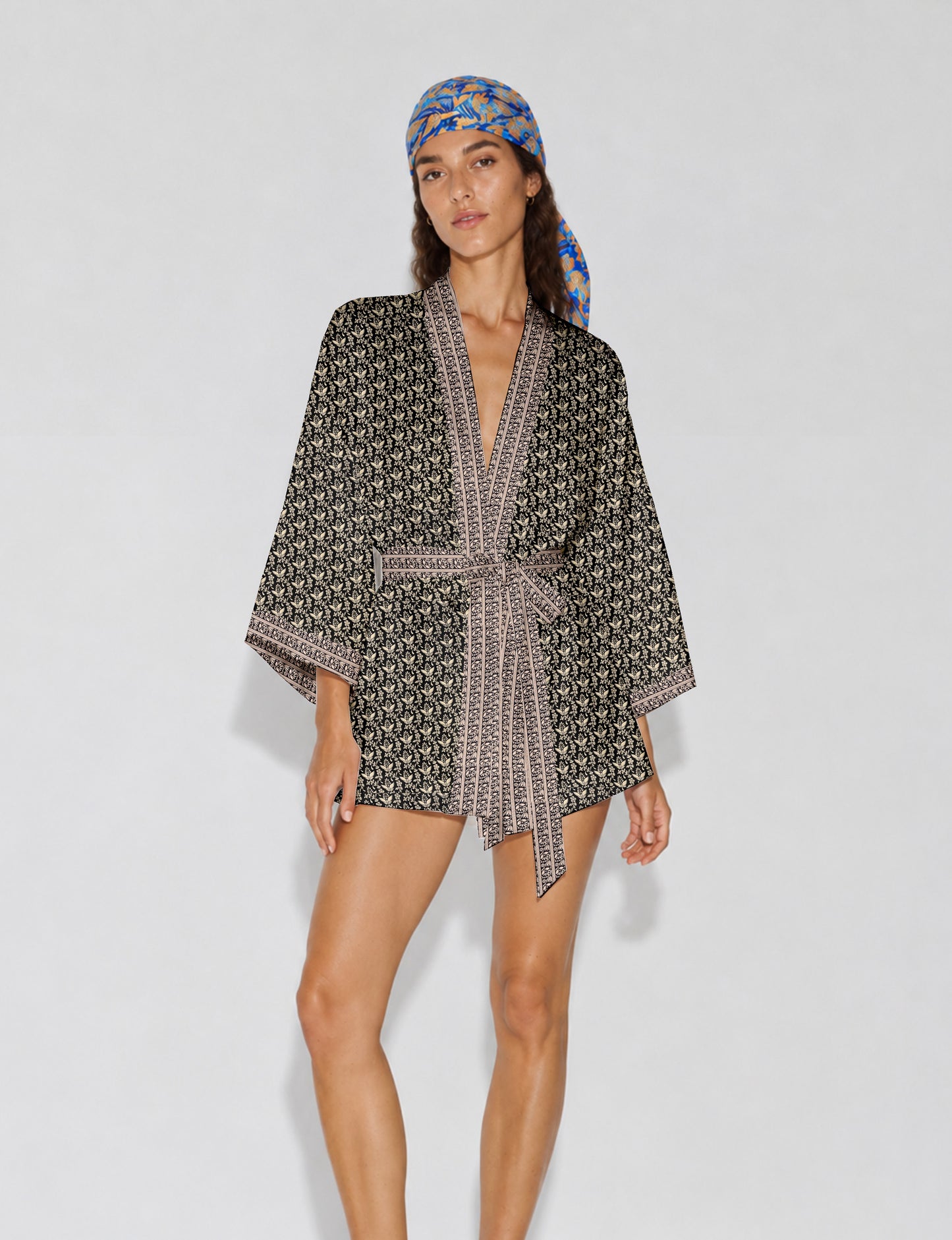 Short kimono robe with wrap front, V-neckline, wide sleeves, waist tie, and concealed skort detail.