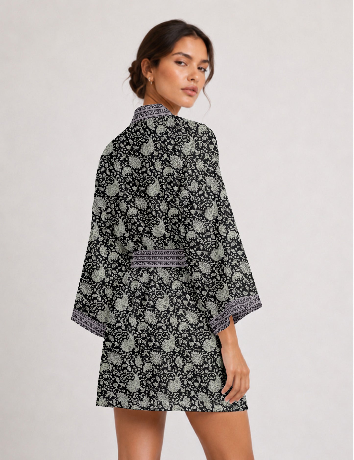 Short kimono robe with wrap front, V-neckline, wide sleeves, waist tie, and concealed skort detail.