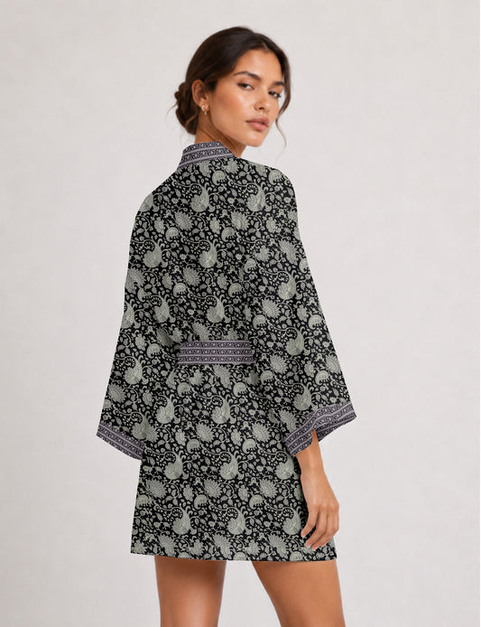 Short kimono robe with wrap front, V-neckline, wide sleeves, waist tie, and concealed skort detail.