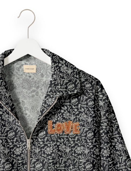Love Bomber Jacket made from recycled fabric, featuring hand-stitched Aari embroidery. A unique piece of zero-waste clothing, part of the circular fashion movement. Designed with upcycled materials for a stylish yet environmentally friendly clothing choice.