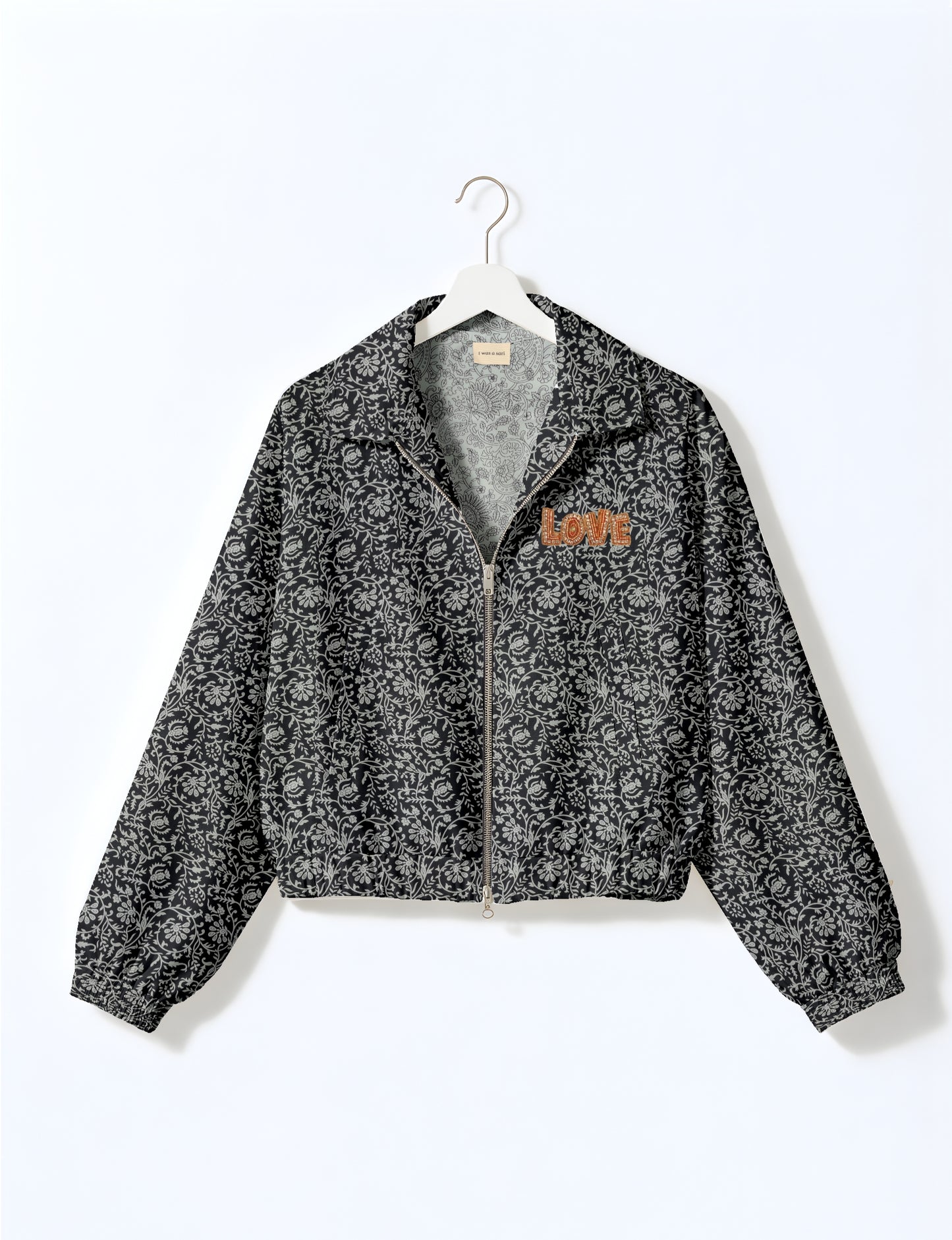 Love Bomber Jacket made from recycled fabric, featuring hand-stitched Aari embroidery. A unique piece of zero-waste clothing, part of the circular fashion movement. Designed with upcycled materials for a stylish yet environmentally friendly clothing choice.