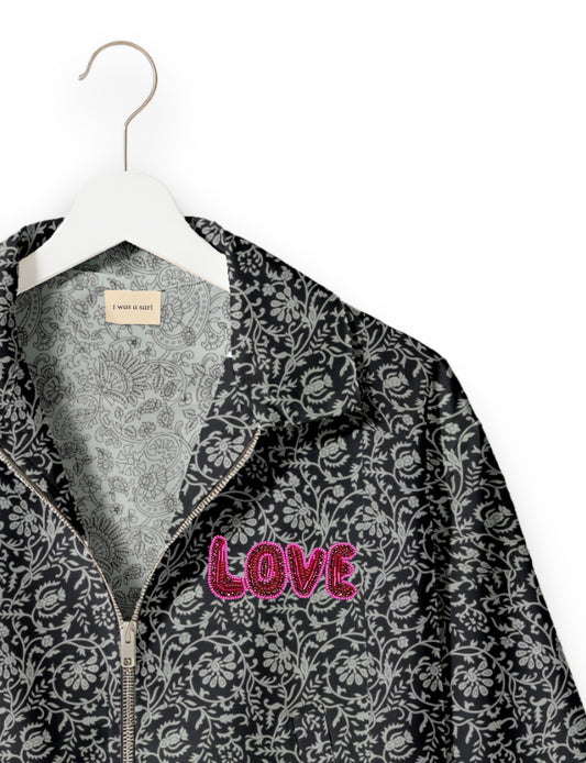 Love Bomber Jacket made from recycled fabric, featuring hand-stitched Aari embroidery. A unique piece of zero-waste clothing, part of the circular fashion movement. Designed with upcycled materials for a stylish yet environmentally friendly clothing choice.