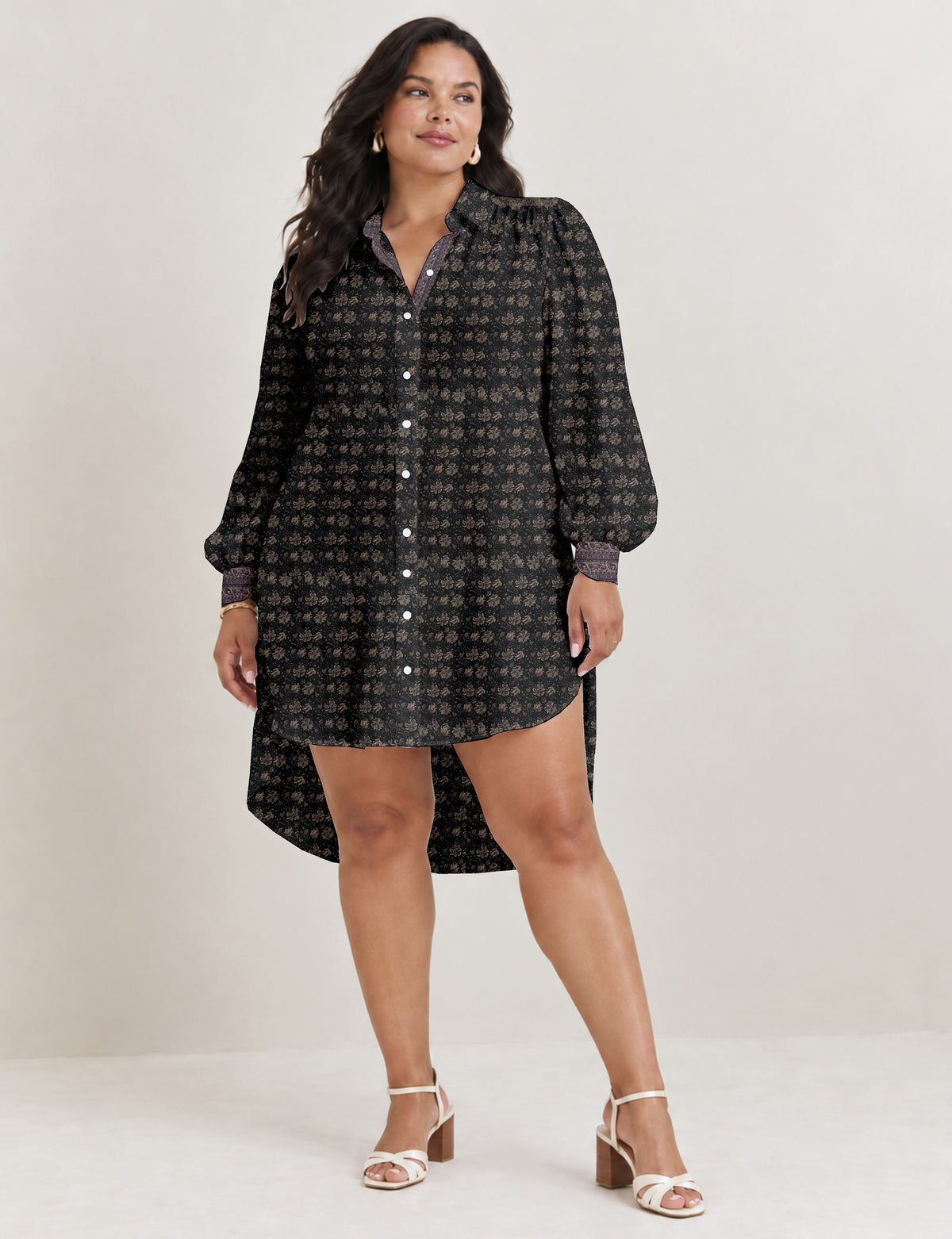 High low shirt with a relaxed fit, button-down front, classic collar, gathered shoulders and full-length blouson sleeves.