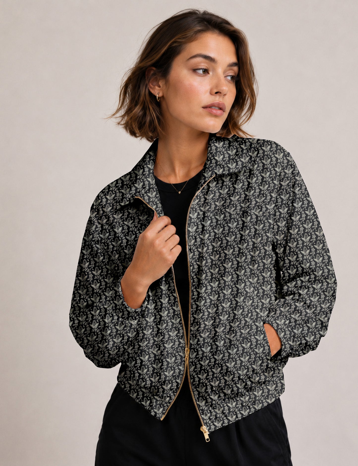 Woman wearing a yellow floral bomber jacket with front zipper, elastic cuffs, and side pockets, shown from front view