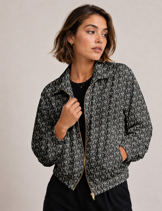 Woman wearing a yellow floral bomber jacket with front zipper, elastic cuffs, and side pockets, shown from front view