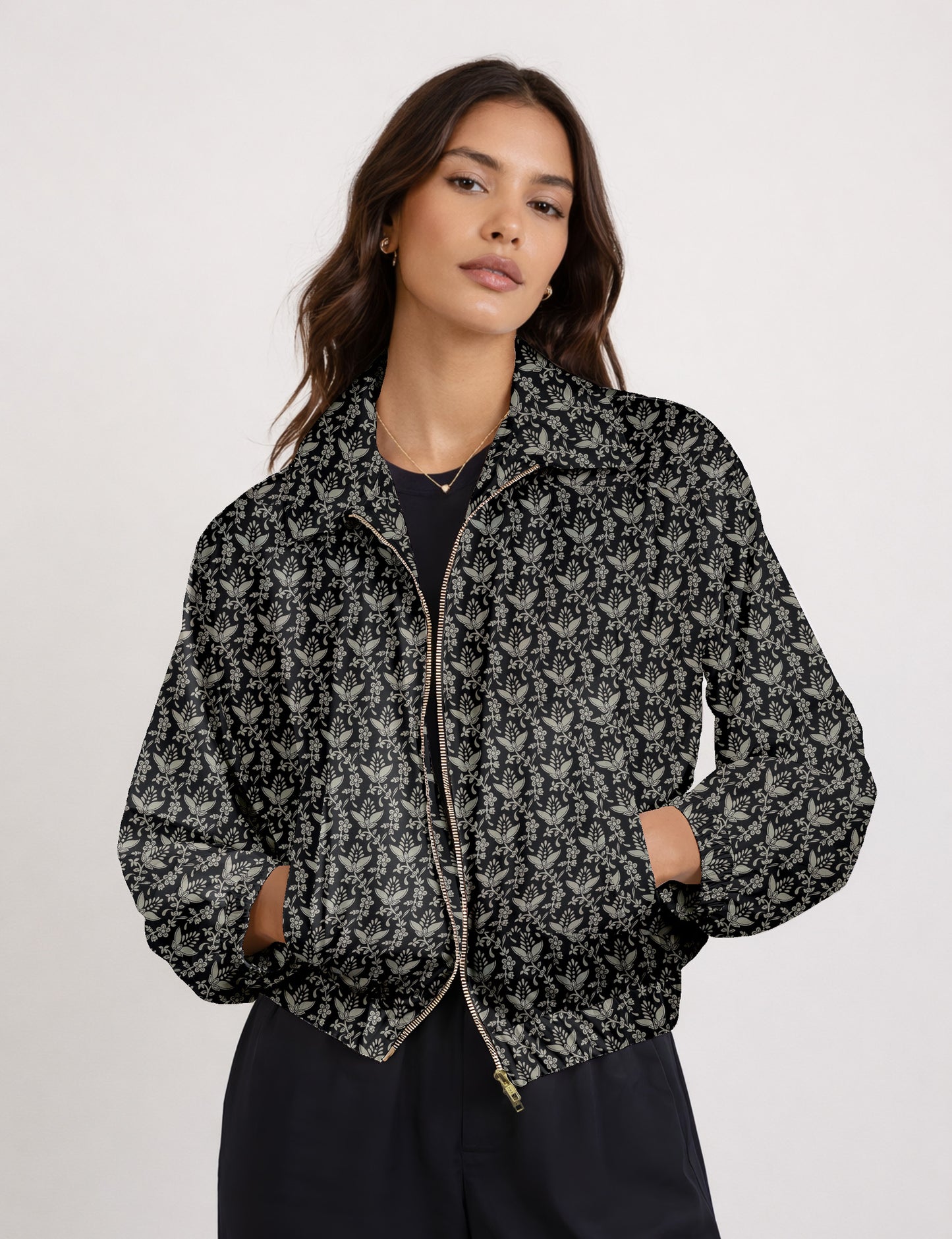 Brown floral bomber jacket with front zipper, elastic cuffs and hem, hanging on white hanger, red floral inner lining visible