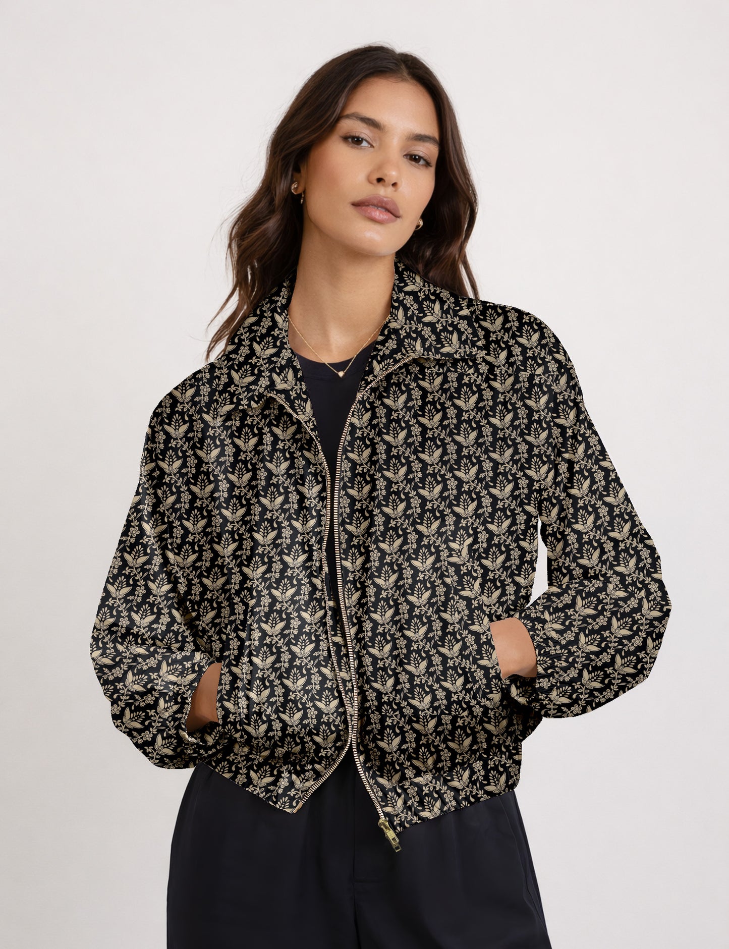 Brown floral bomber jacket with front zipper, elastic cuffs and hem, hanging on white hanger, red floral inner lining visible