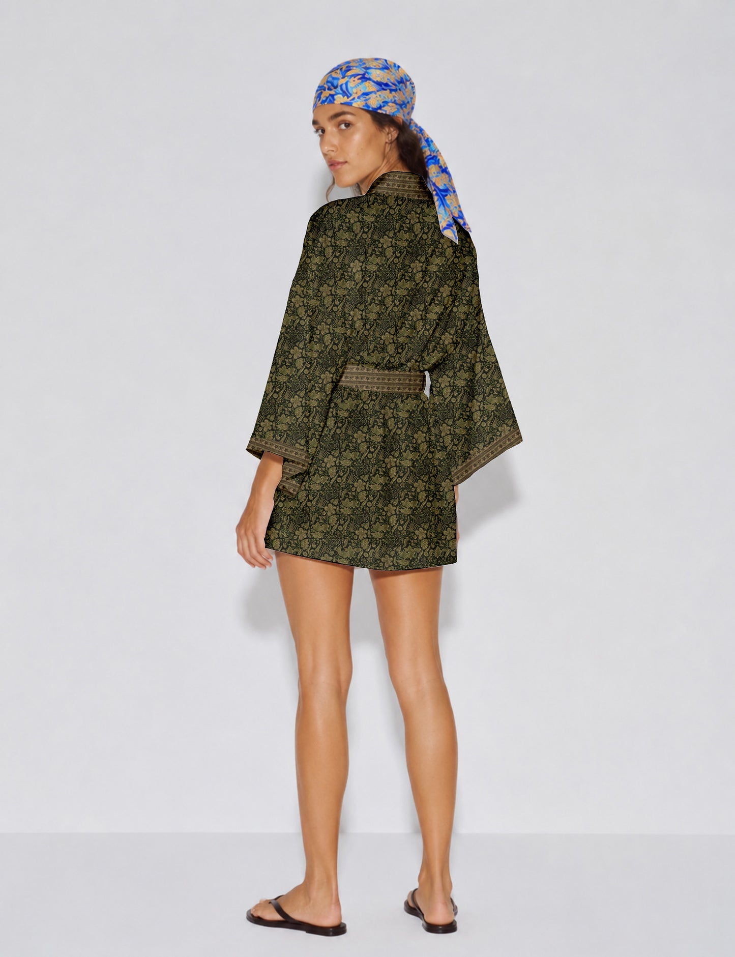 Short kimono robe with wrap front, V-neckline, wide sleeves, waist tie, and concealed skort detail.