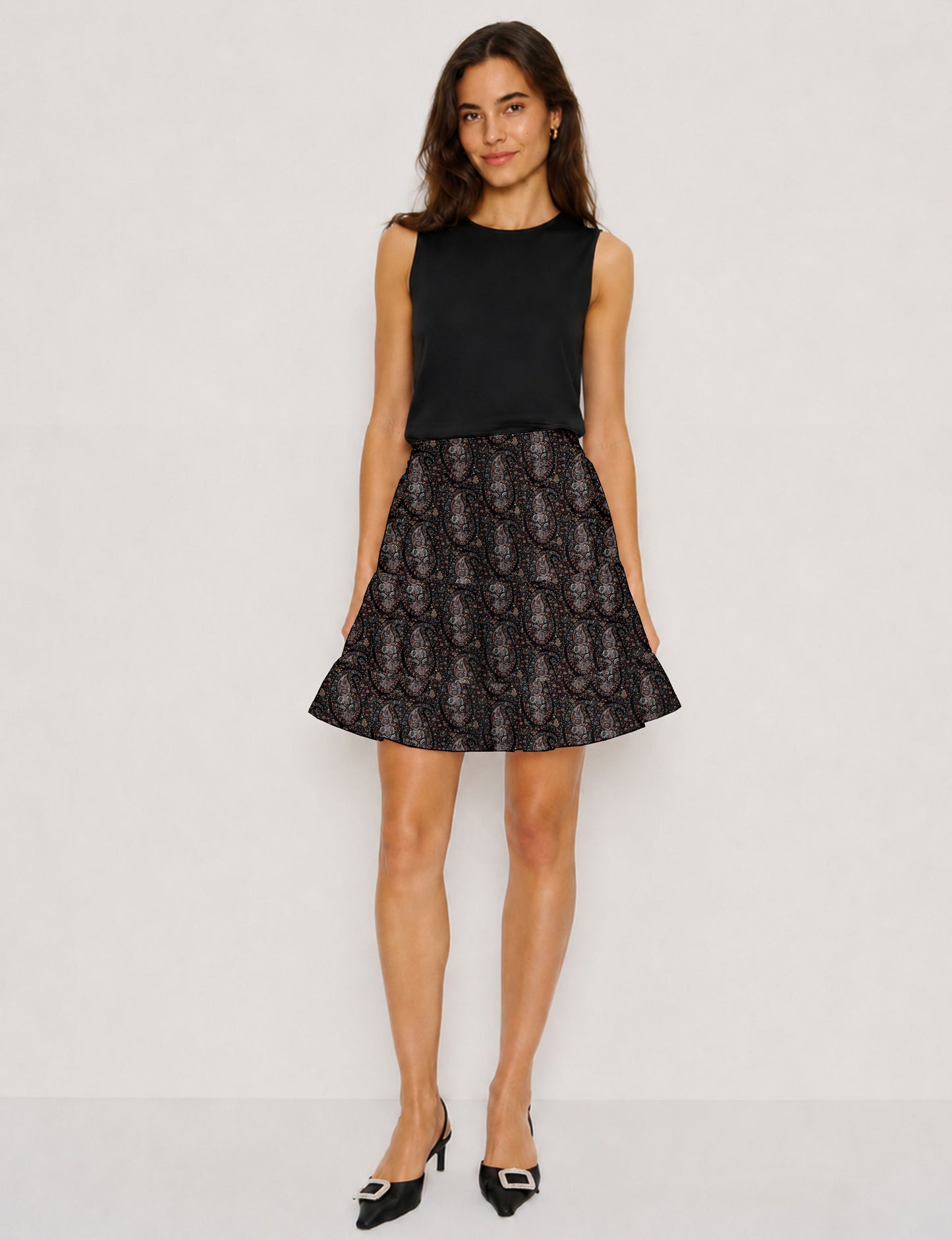 Short tiered skirt with a fitted waistband, knife pleats, softly flared silhouette, side seam pockets, and above-the-knee length.
