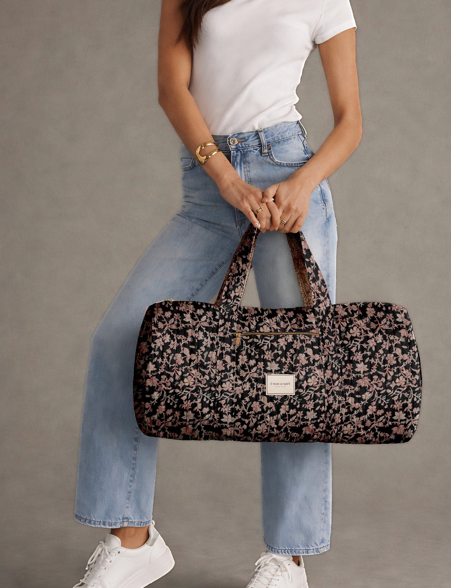 Brown paisley quilted bowling bag with dual handles, front zipper pocket, and "I was a sari" label on front side