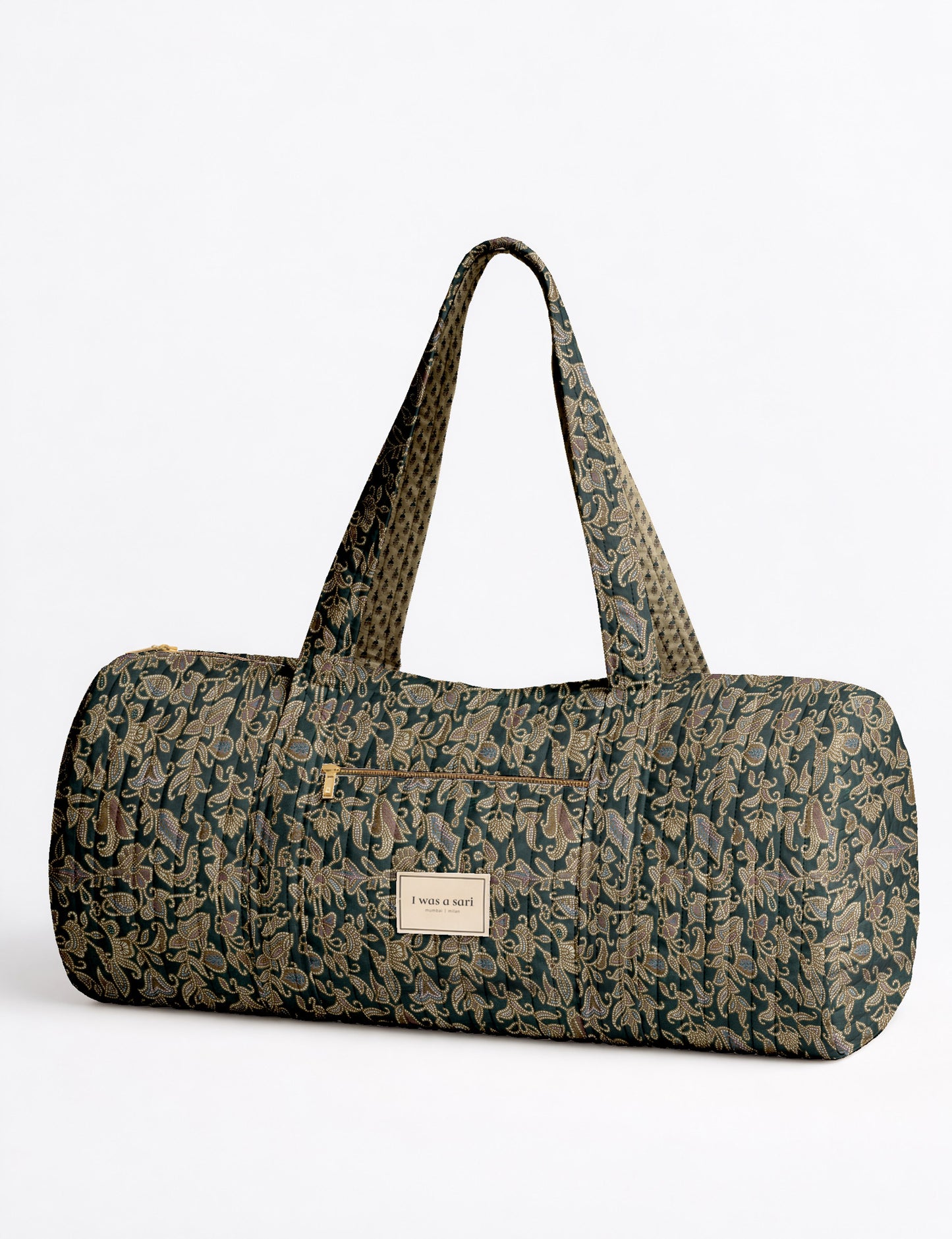 Brown paisley quilted bowling bag with dual handles, front zipper pocket, and "I was a sari" label on front side