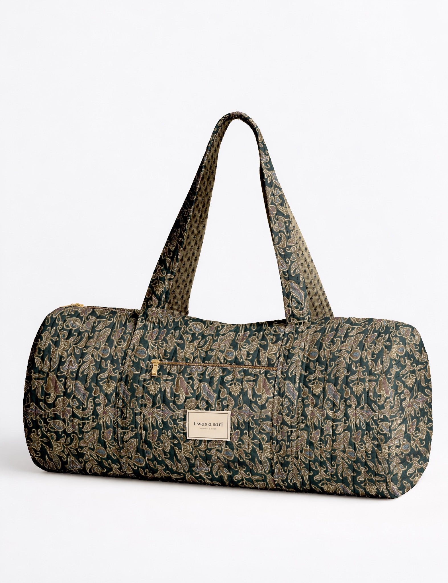 Brown paisley quilted bowling bag with dual handles, front zipper pocket, and "I was a sari" label on front side