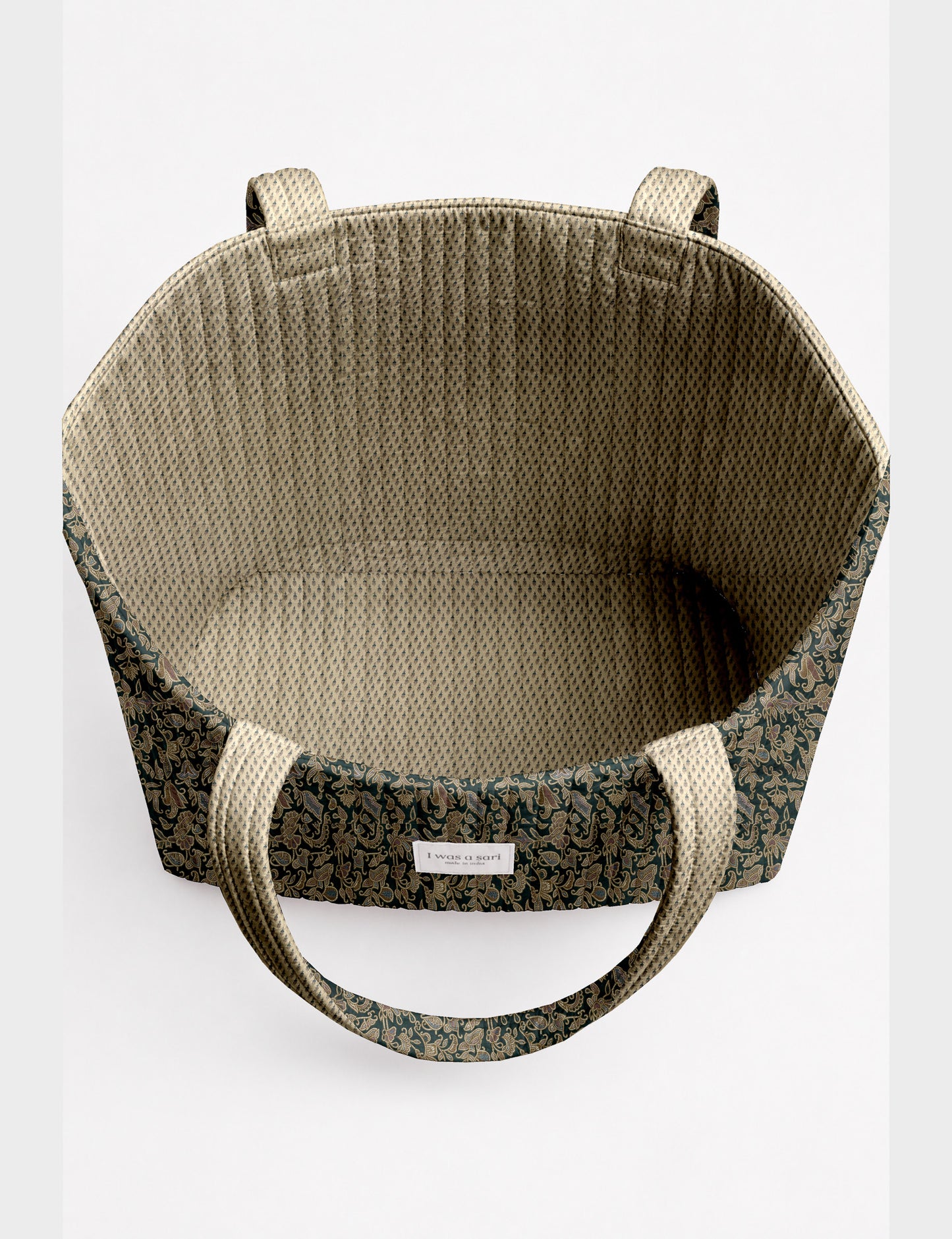 Quilted beach bag with yellow tropical exterior and red patterned interior, shown from top view with handles visible