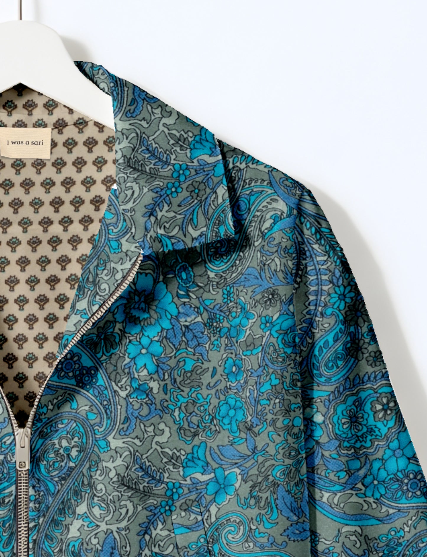 Upcycled Bomber Jacket made from recycled sari materials, featuring a cute cropped shape, elasticated hem and cuffs, and contrast sari print lining. Sustainable apparel promoting eco-friendly fashion and ethical clothing.