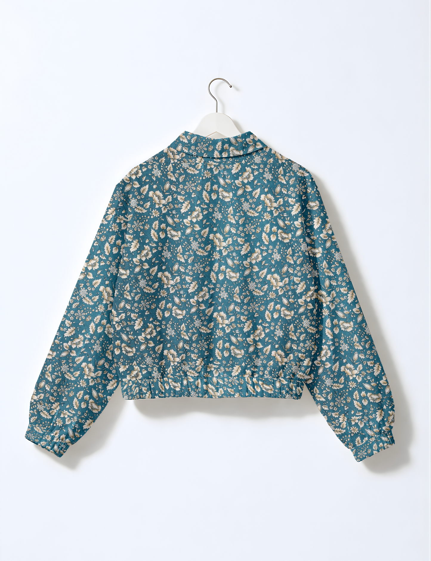 Women's cropped bomber jacket with twin metallic front zippers, welt pockets, elasticated hem and cuffs, and contrast sari print lining.